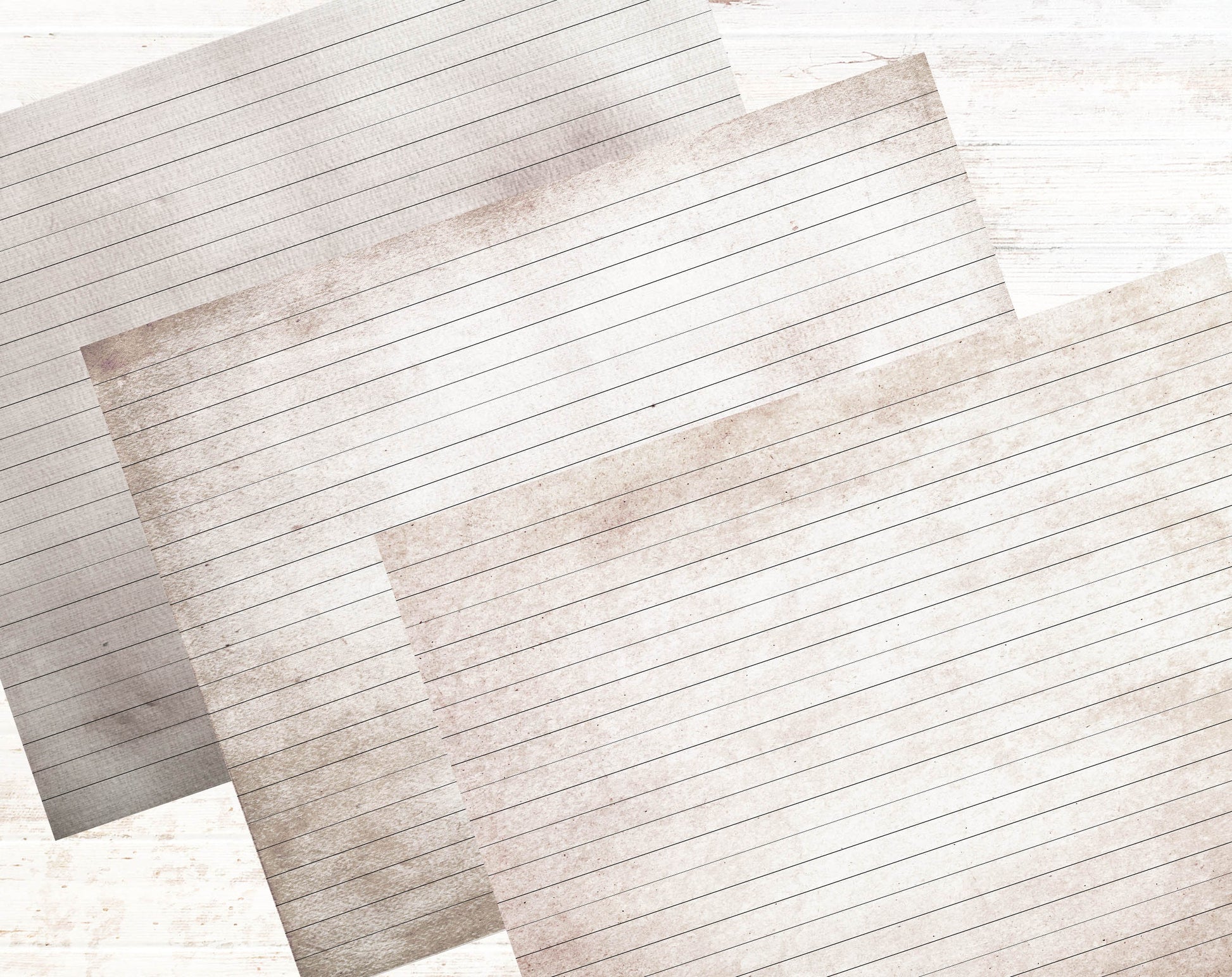 a pile of lined paper sitting on top of a wooden table